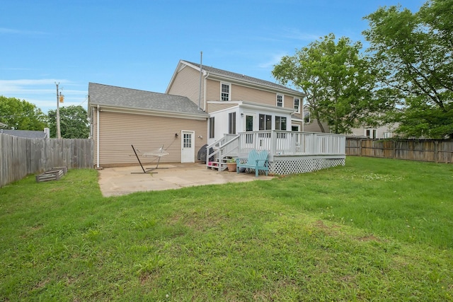 back of property featuring a yard, a patio area, and a wooden deck