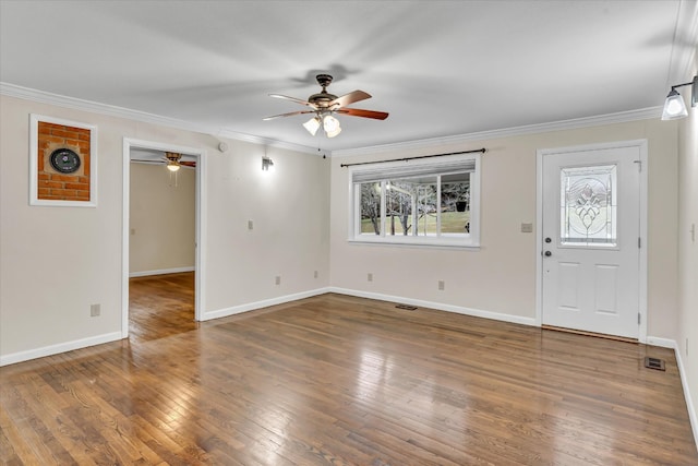 foyer entrance featuring dark hardwood / wood-style flooring and ornamental molding