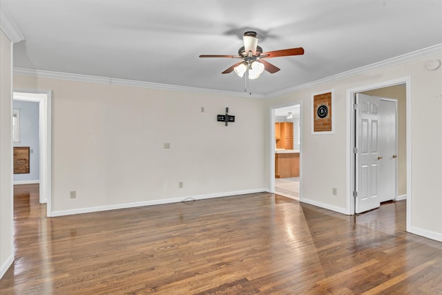 spare room featuring dark hardwood / wood-style floors, ceiling fan, and crown molding