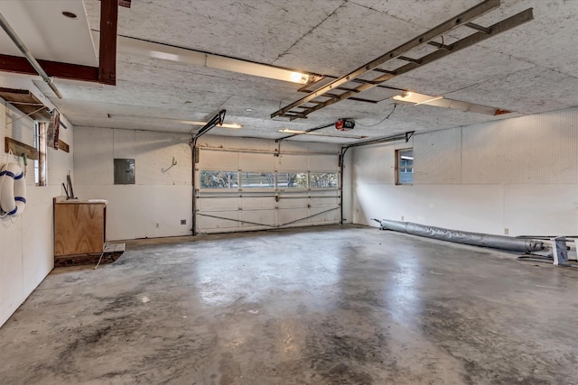 garage featuring a garage door opener and electric panel