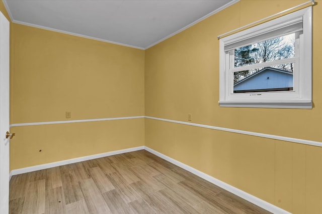 empty room featuring hardwood / wood-style flooring and crown molding