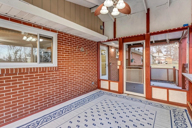 unfurnished sunroom with ceiling fan