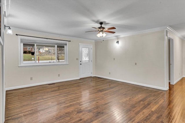 empty room with ceiling fan, dark hardwood / wood-style flooring, and ornamental molding