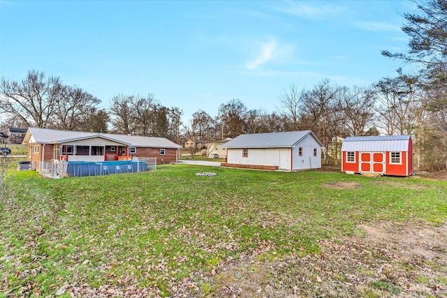 view of yard featuring a pool and a storage shed