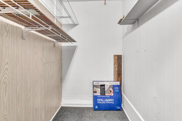 walk in closet featuring dark colored carpet