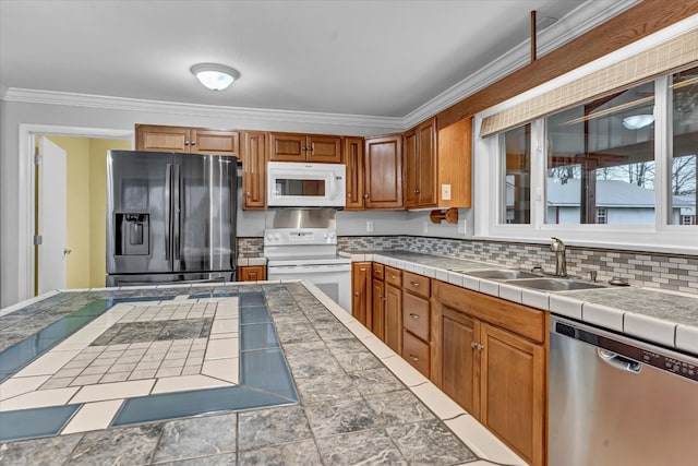 kitchen featuring tasteful backsplash, tile counters, stainless steel appliances, and sink