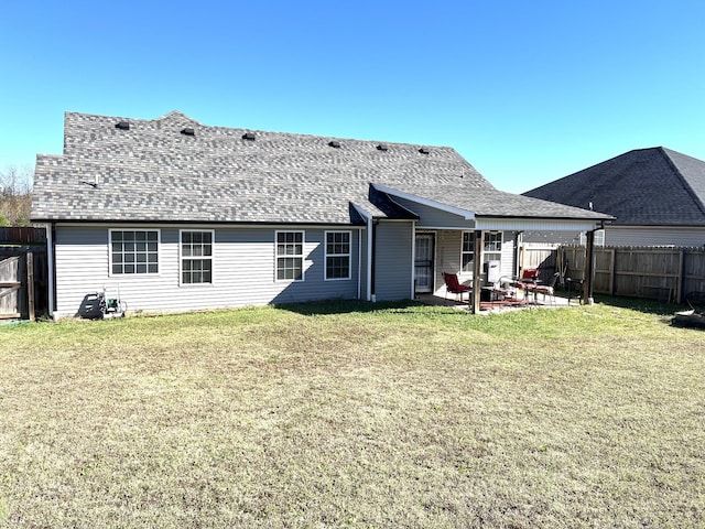 back of property featuring a patio area and a yard