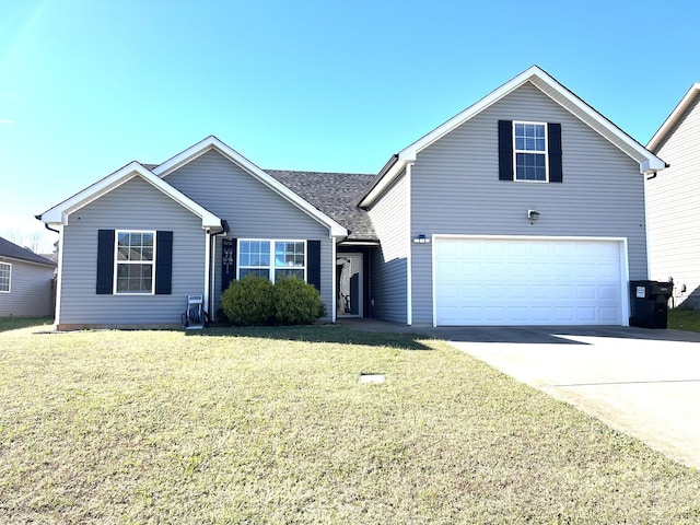 view of front of property featuring a front yard and a garage