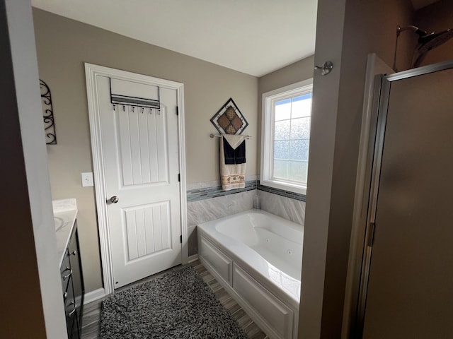 bathroom with vanity, wood-type flooring, and shower with separate bathtub