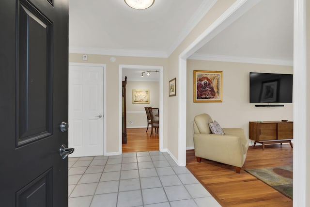 entrance foyer featuring light wood-type flooring and crown molding