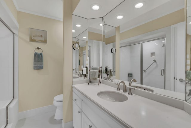 bathroom with vanity, toilet, a shower with door, and crown molding