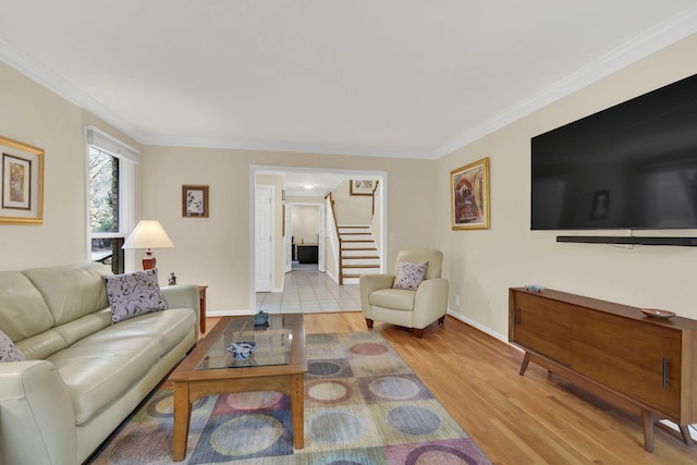 living room with light hardwood / wood-style floors and ornamental molding