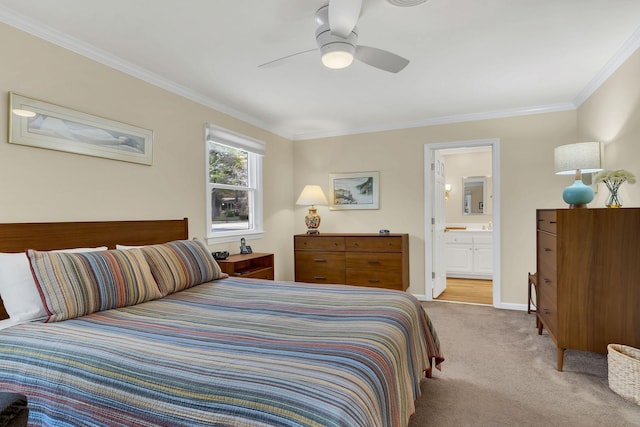 bedroom featuring ceiling fan, crown molding, light carpet, and ensuite bath