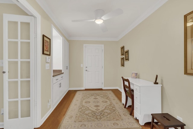 interior space featuring hardwood / wood-style flooring, ceiling fan, and ornamental molding