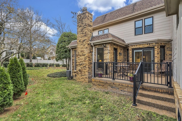 rear view of house featuring a yard