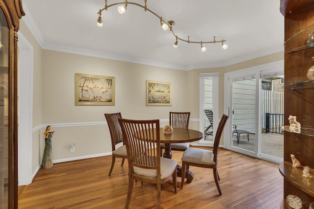 dining area featuring hardwood / wood-style floors and crown molding