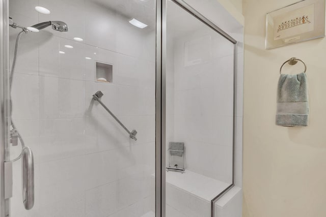 bathroom with a shower with door