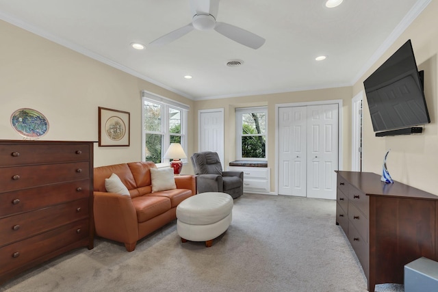 interior space featuring light colored carpet, ceiling fan, and crown molding