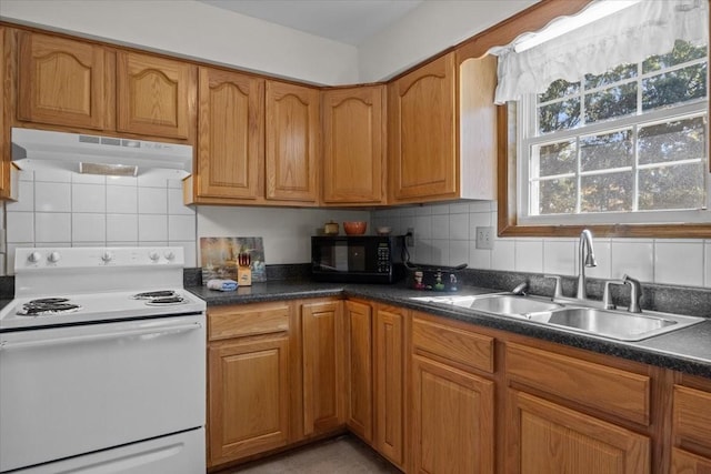 kitchen with tasteful backsplash, white range with electric cooktop, and sink