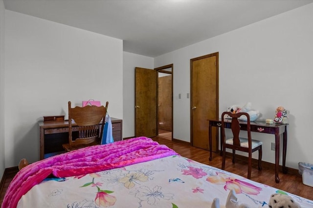 bedroom with dark wood-type flooring