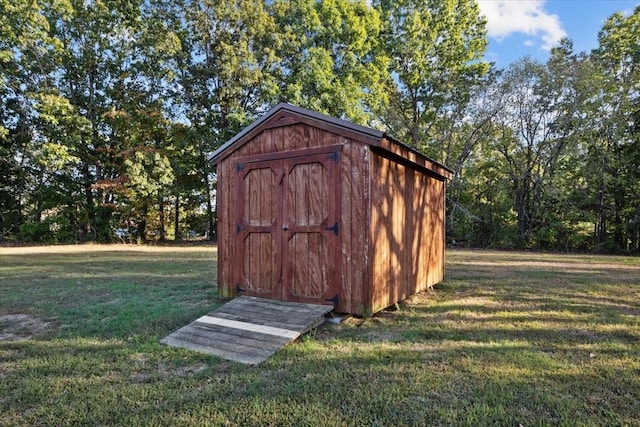 view of outbuilding featuring a lawn