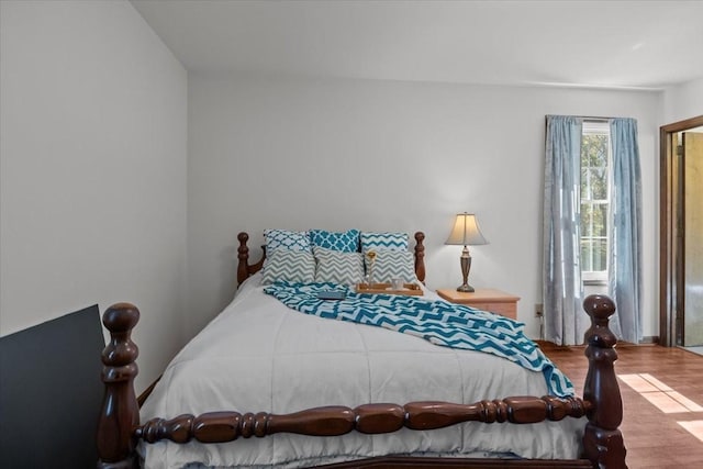 bedroom with wood-type flooring