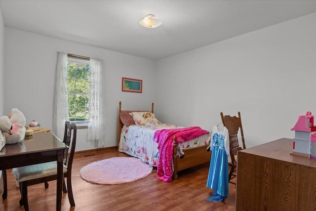 bedroom with hardwood / wood-style flooring