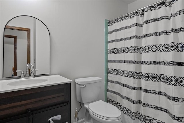 bathroom featuring a shower with shower curtain, vanity, and toilet