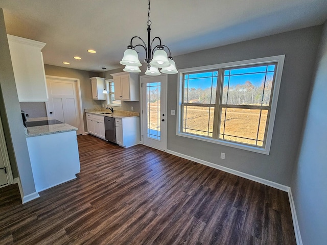 kitchen featuring dishwasher, dark wood-type flooring, an inviting chandelier, white cabinets, and decorative light fixtures