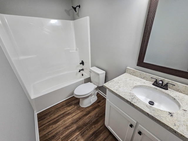 full bathroom featuring shower / bathing tub combination, hardwood / wood-style floors, vanity, and toilet