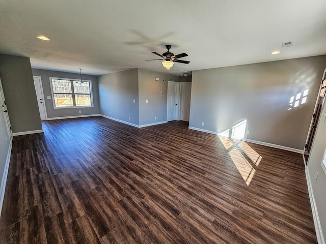 empty room with dark hardwood / wood-style floors and ceiling fan