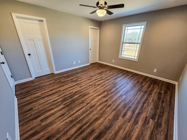 unfurnished room featuring ceiling fan and dark wood-type flooring