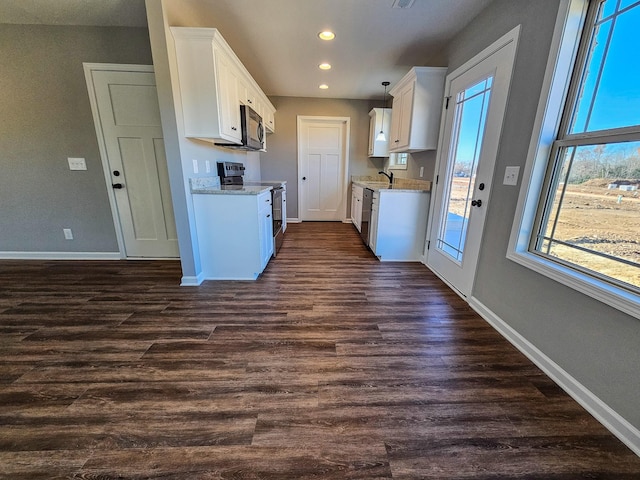 kitchen with stainless steel electric stove, plenty of natural light, white cabinets, and dark hardwood / wood-style floors