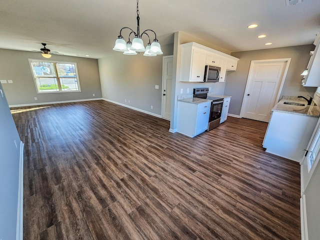 kitchen featuring white cabinets, appliances with stainless steel finishes, ceiling fan with notable chandelier, and dark hardwood / wood-style floors