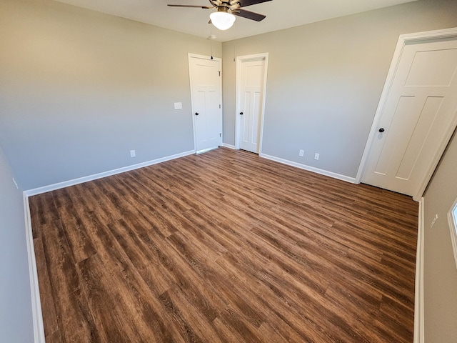 spare room with ceiling fan and dark wood-type flooring