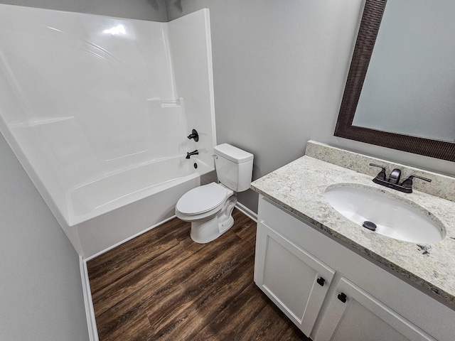 full bathroom with toilet, wood-type flooring, vanity, and bathing tub / shower combination