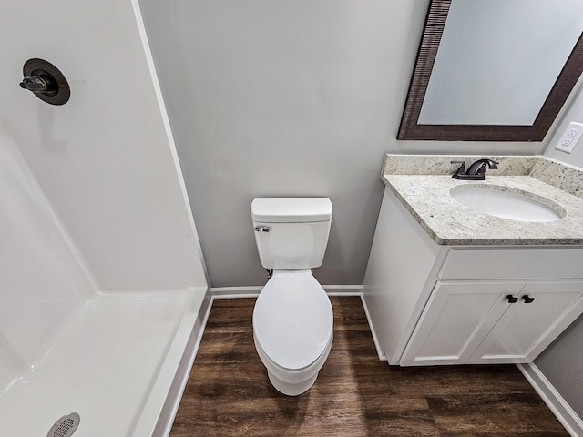 bathroom featuring toilet, vanity, and hardwood / wood-style flooring