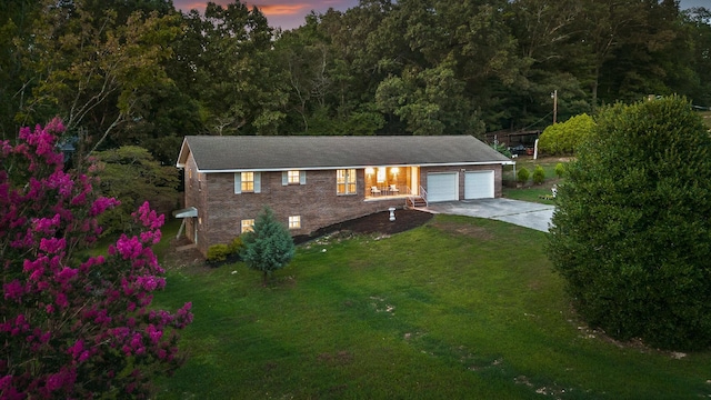 view of front facade with a lawn and a garage