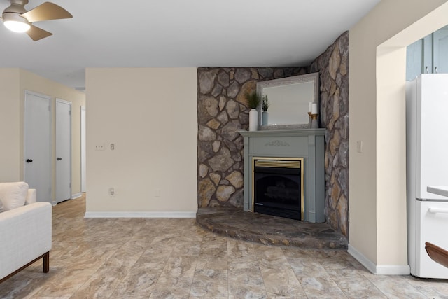 living room with a large fireplace and ceiling fan