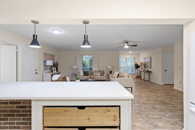 kitchen with ceiling fan and hanging light fixtures