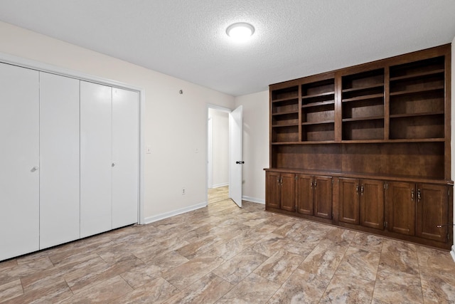 unfurnished bedroom featuring a closet and a textured ceiling