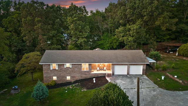 view of front of home with a yard and a garage