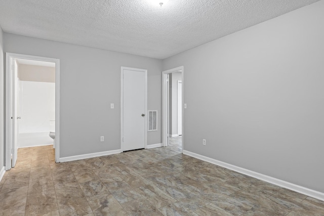 spare room featuring a textured ceiling