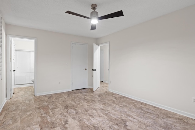 unfurnished bedroom featuring a textured ceiling, a closet, ceiling fan, and connected bathroom