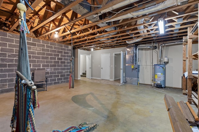 basement featuring heating unit and water heater