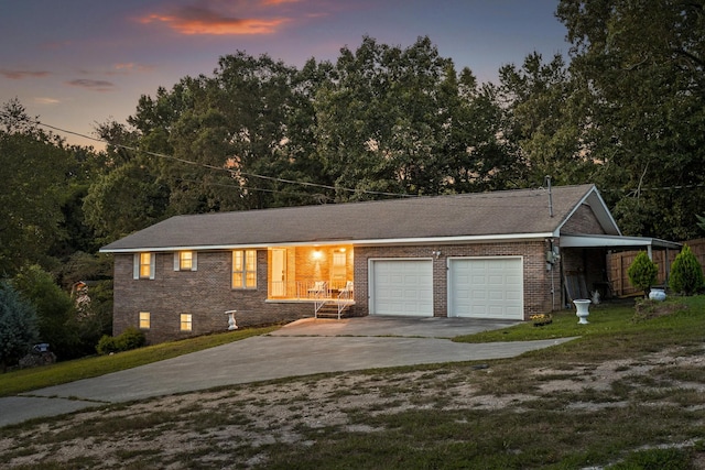 view of front of house with a yard and a garage