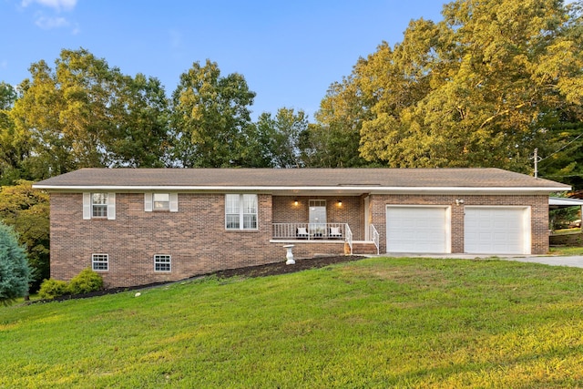 view of front of property with a porch, a front yard, and a garage