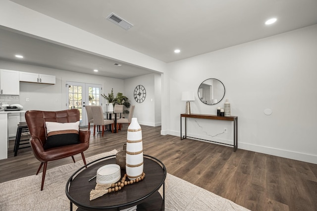 living room featuring french doors and dark wood-type flooring