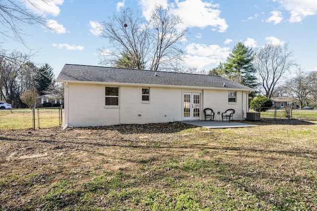 back of house featuring french doors, a patio, central AC unit, and a yard