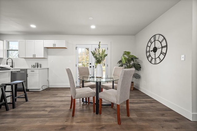 dining space with french doors, dark wood-type flooring, and sink